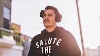 a man wearing headphones standing on a street